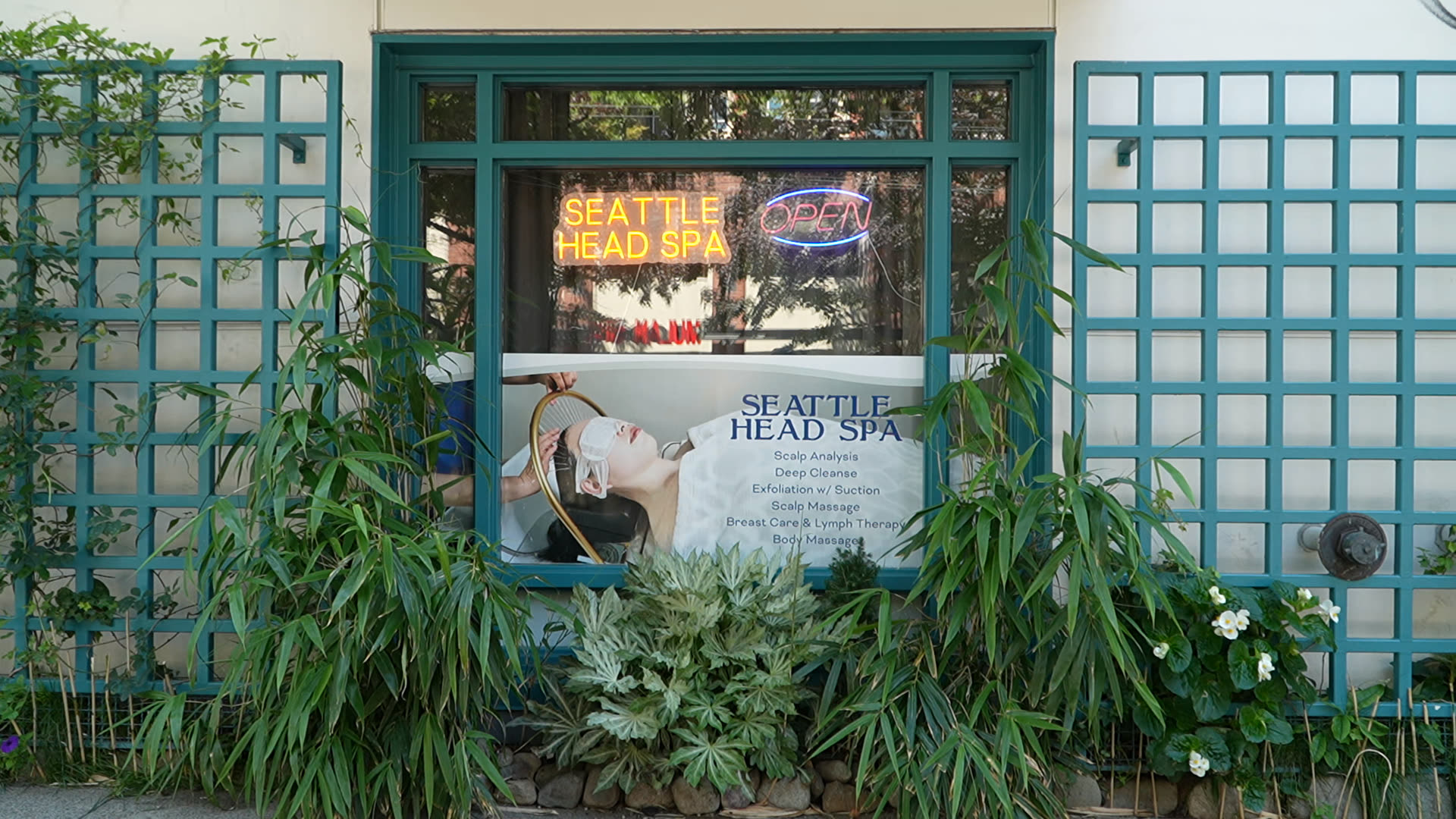 Seattle Head Spa storefront on 1st Ave with its teal trellis and glowing neon window sign